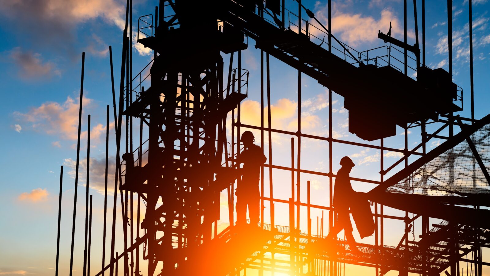 construction-workers-silhouetted-against-bright-su-2026-03-25-23-41-14-utc