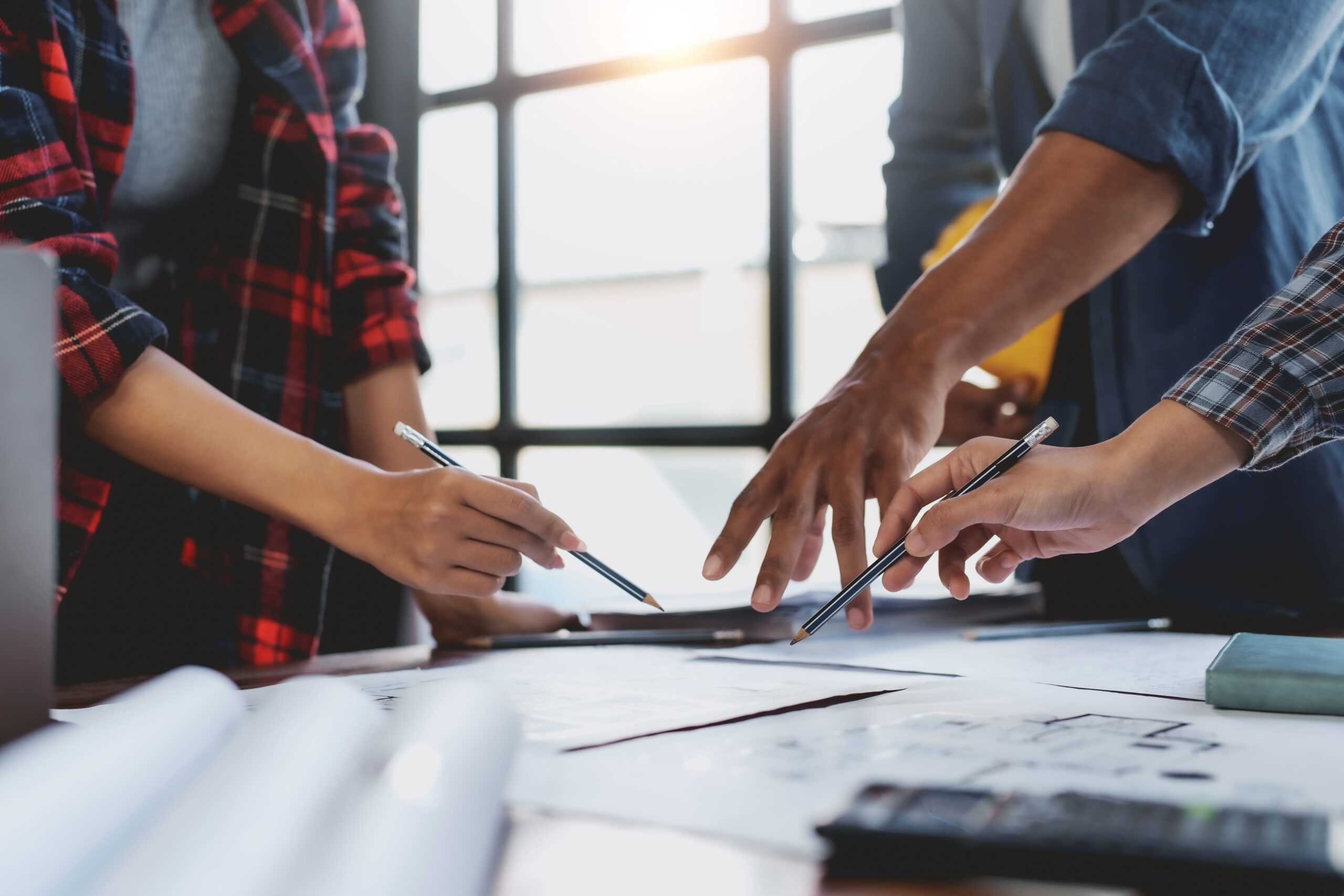team-collaborating-on-plans-in-bright-office-space-2026-03-20-00-34-00-utc